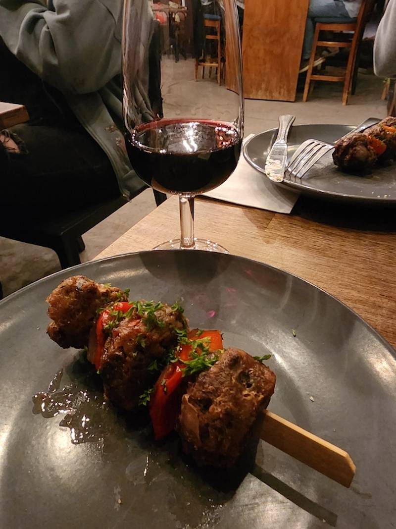 2024 Syrah with Mini lamb kofta with a pomegranate glaze, dark berry, spice, fruity.